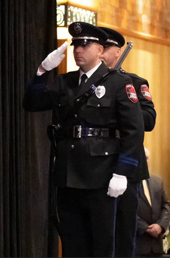 Pekin Police Honor Guard member saluting